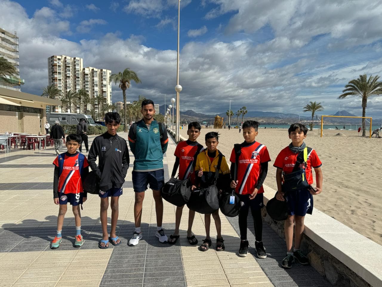 Xdrona players with their coach on the seafront in Alicante, Spain.
